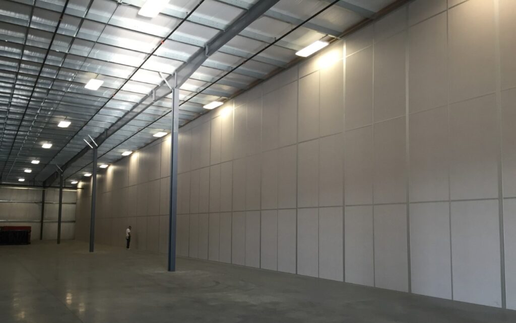 A modular tall wall (demising wall) application within a warehouse.