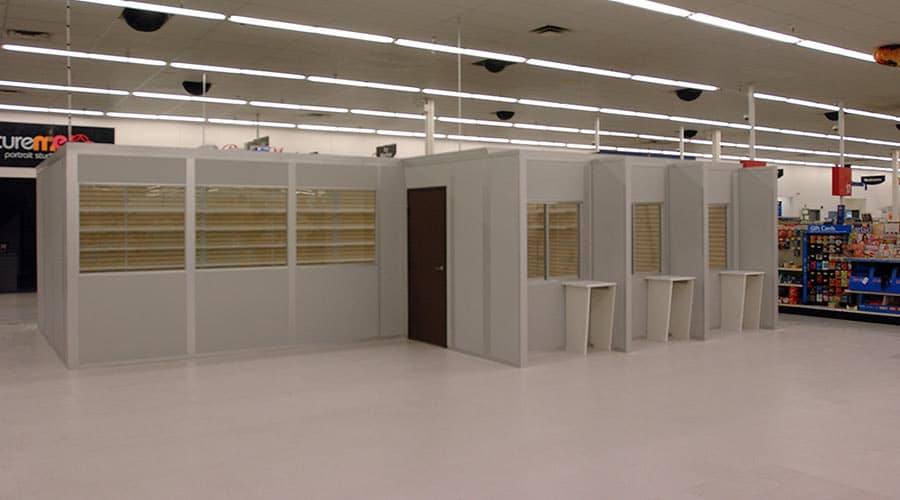 Modular retail buildings by Allied Modular inside a store, featuring prefabricated walls, windows, and service counters.
