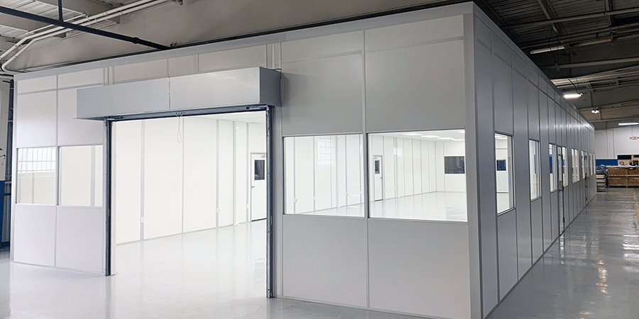 Modular cleanroom with interior windows built by Allied Modular, installed inside a manufacturing facility.