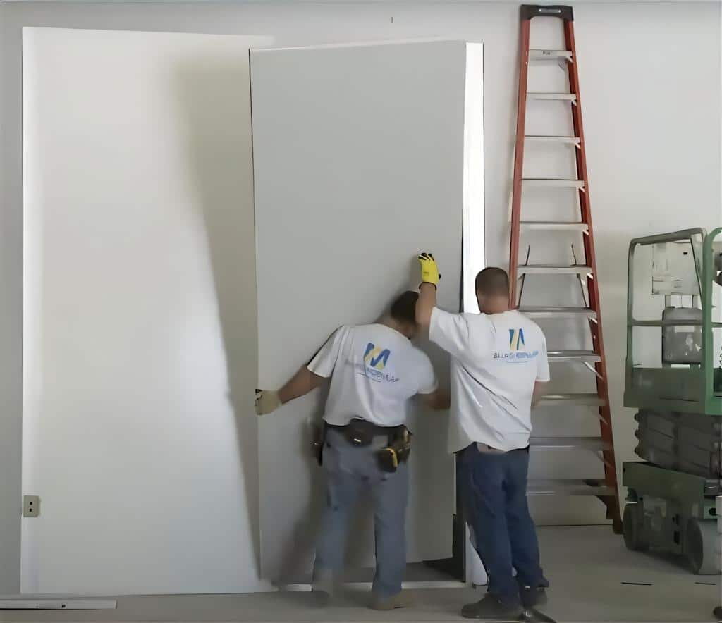 Installers put up a modular panel.