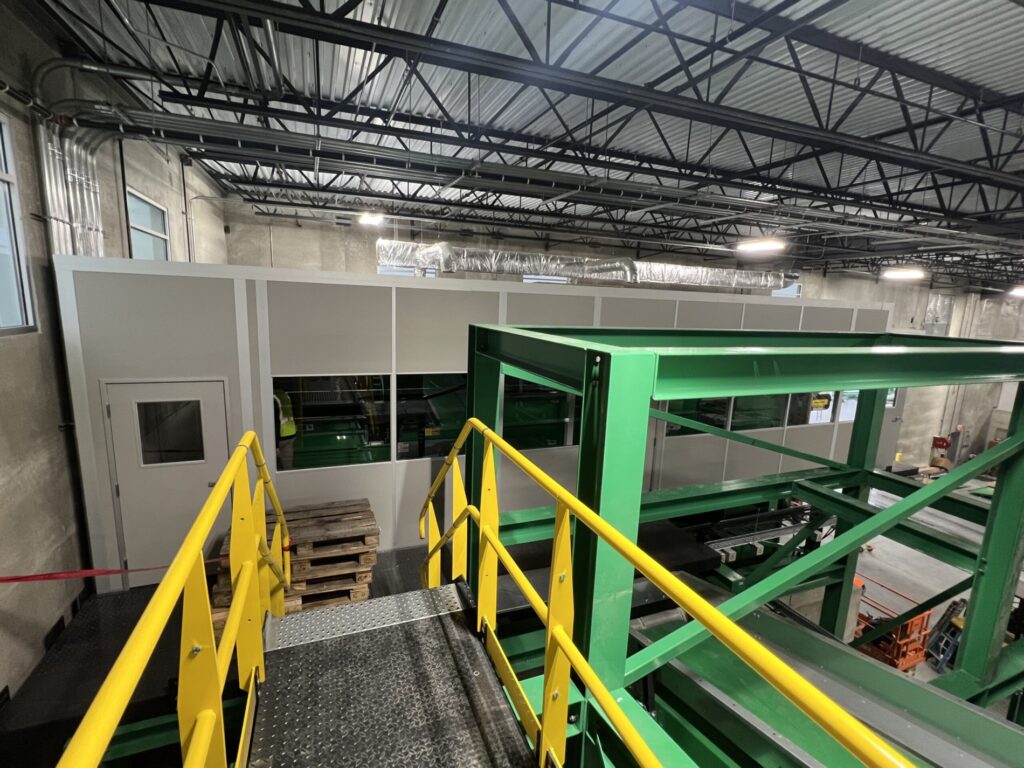 A modular mezzanine (catwalk) structure with safety railings in an industrial setting, designed to manage live loads effectively.