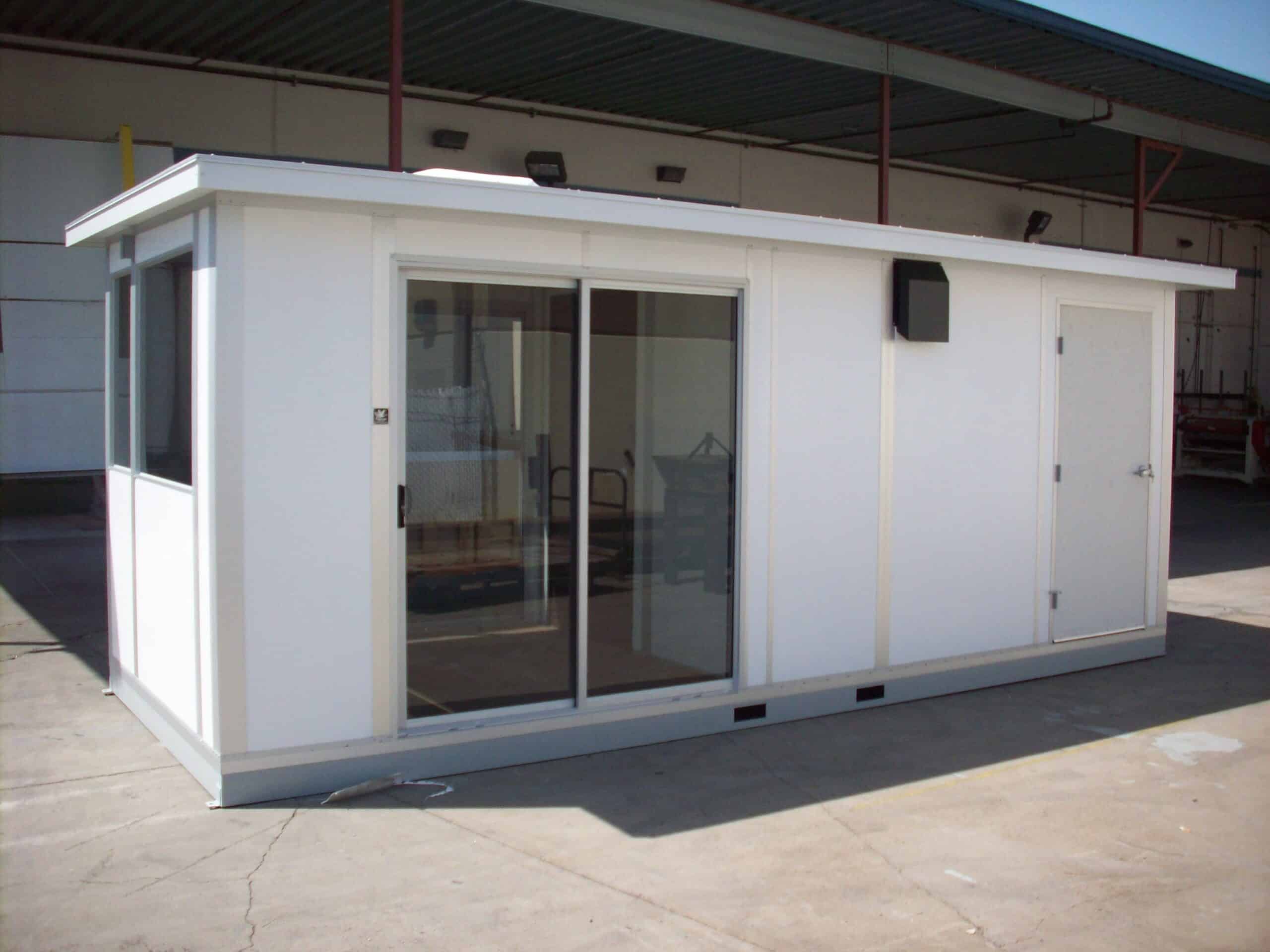A modular scale house with sliding glass doors and a white exterior, designed to accommodate staff and equipment for managing weighbridge operations at industrial sites.