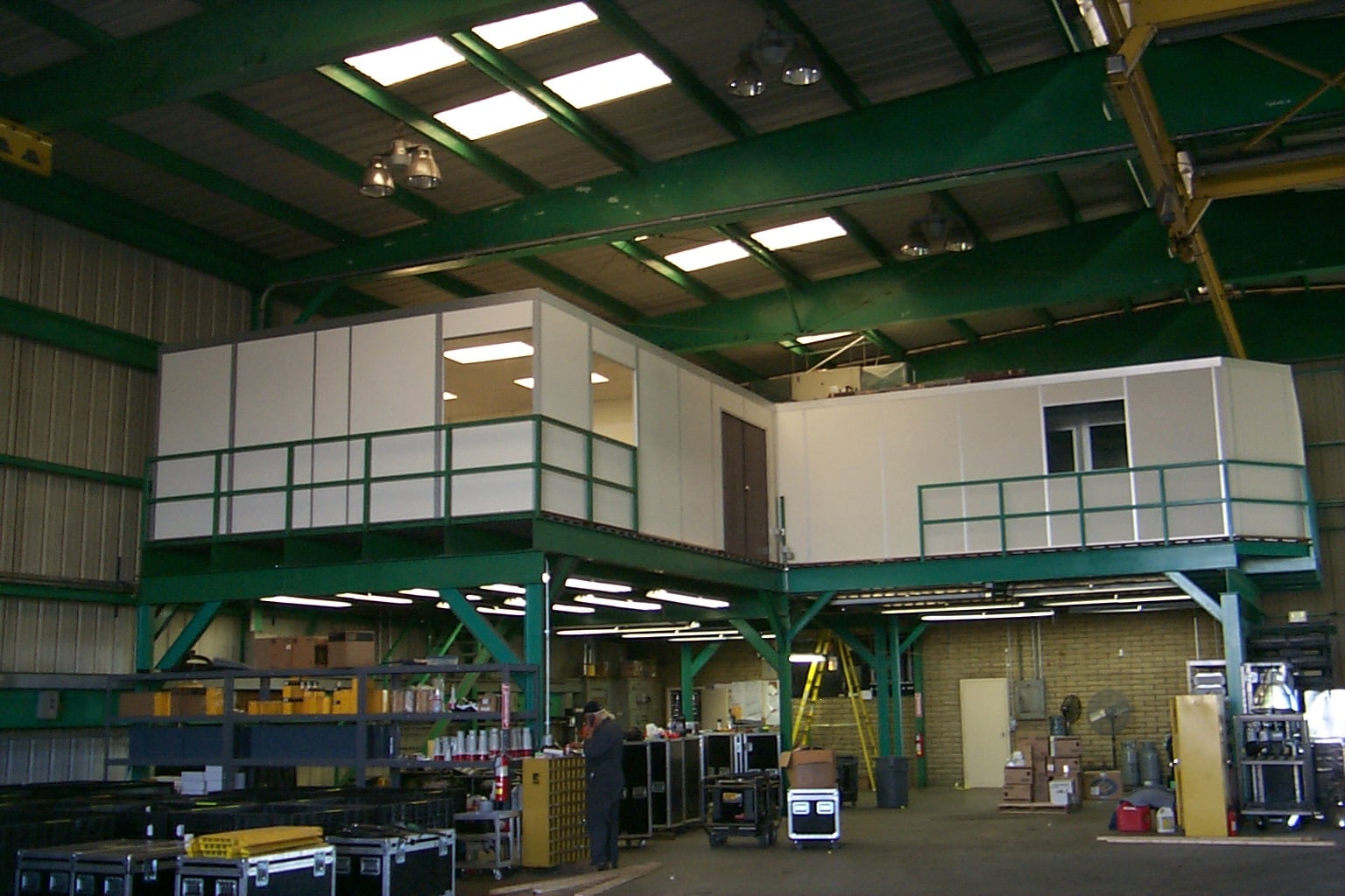 A modular mezzanine (catwalk) structure with safety railings in an industrial setting, designed to manage live loads effectively.