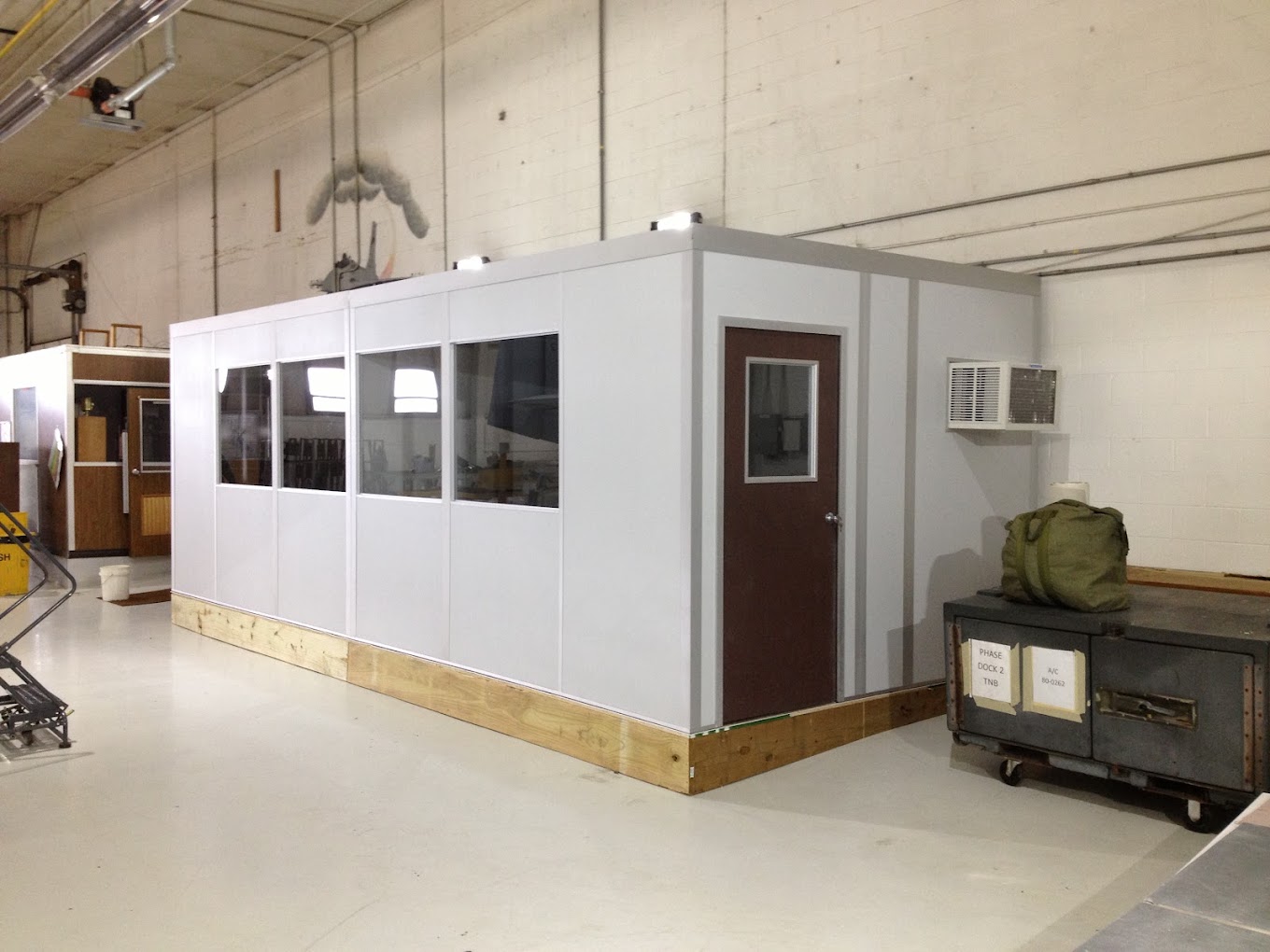 A modular cool down room installed in an industrial setting, featuring air conditioning, windows for visibility, and a secure door for controlled access. The space provides a cool environment where workers can take breaks and recover from heat exposure by allied modular building system - modular buildings