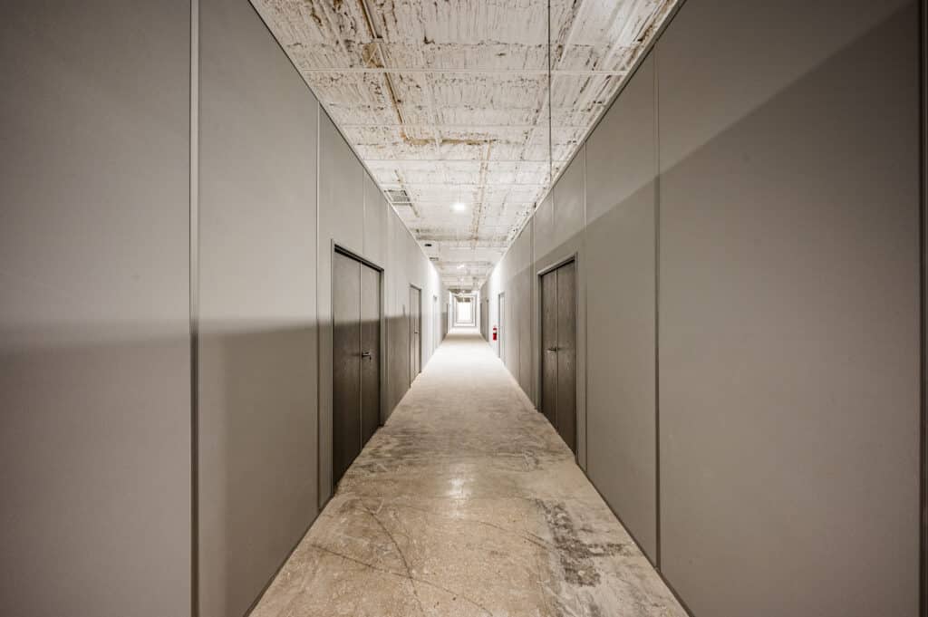 Hallway with modular partition walls and integrated doors by Allied Modular.