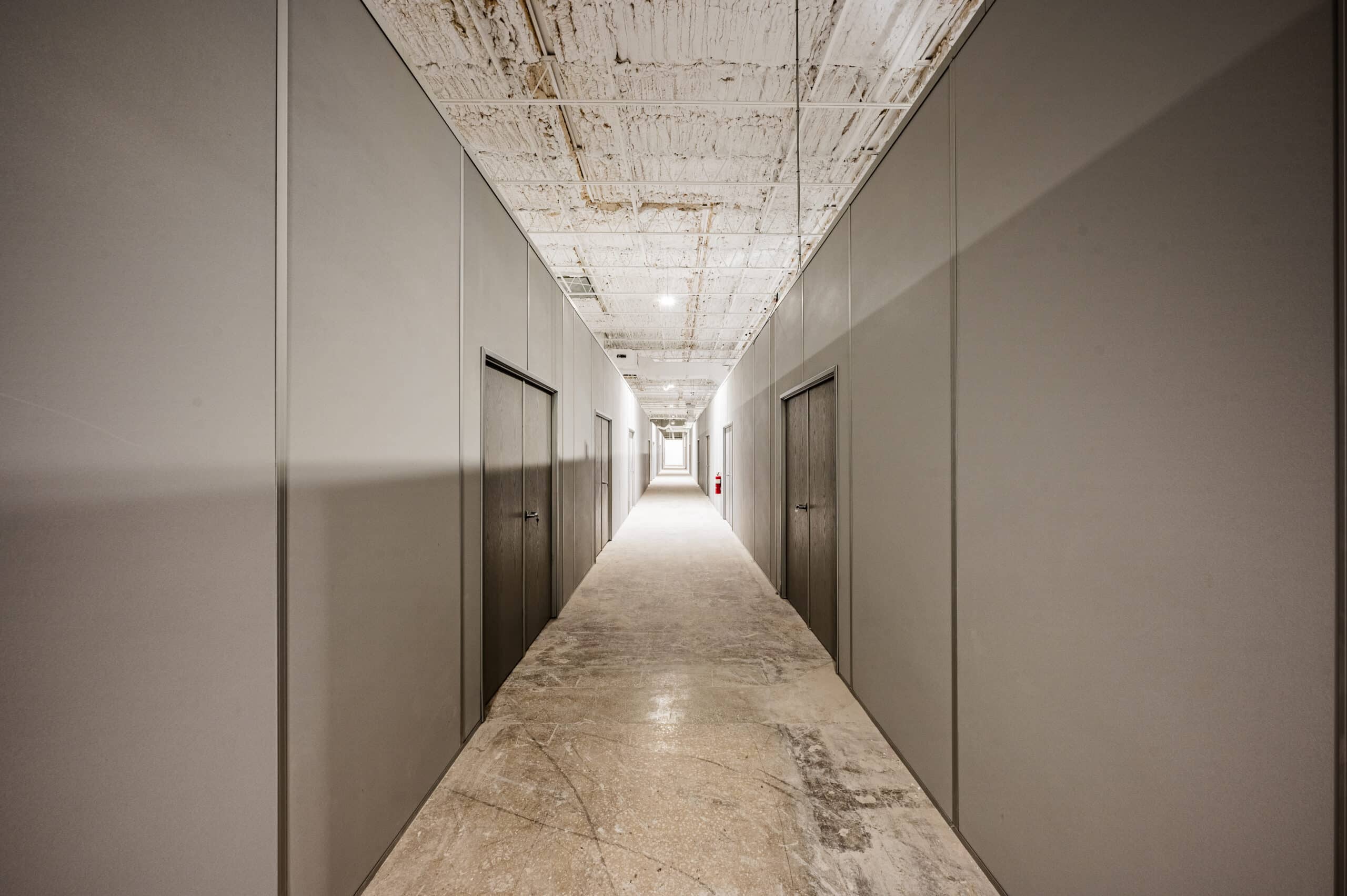 Hallway with modular partition walls and integrated doors by Allied Modular.
