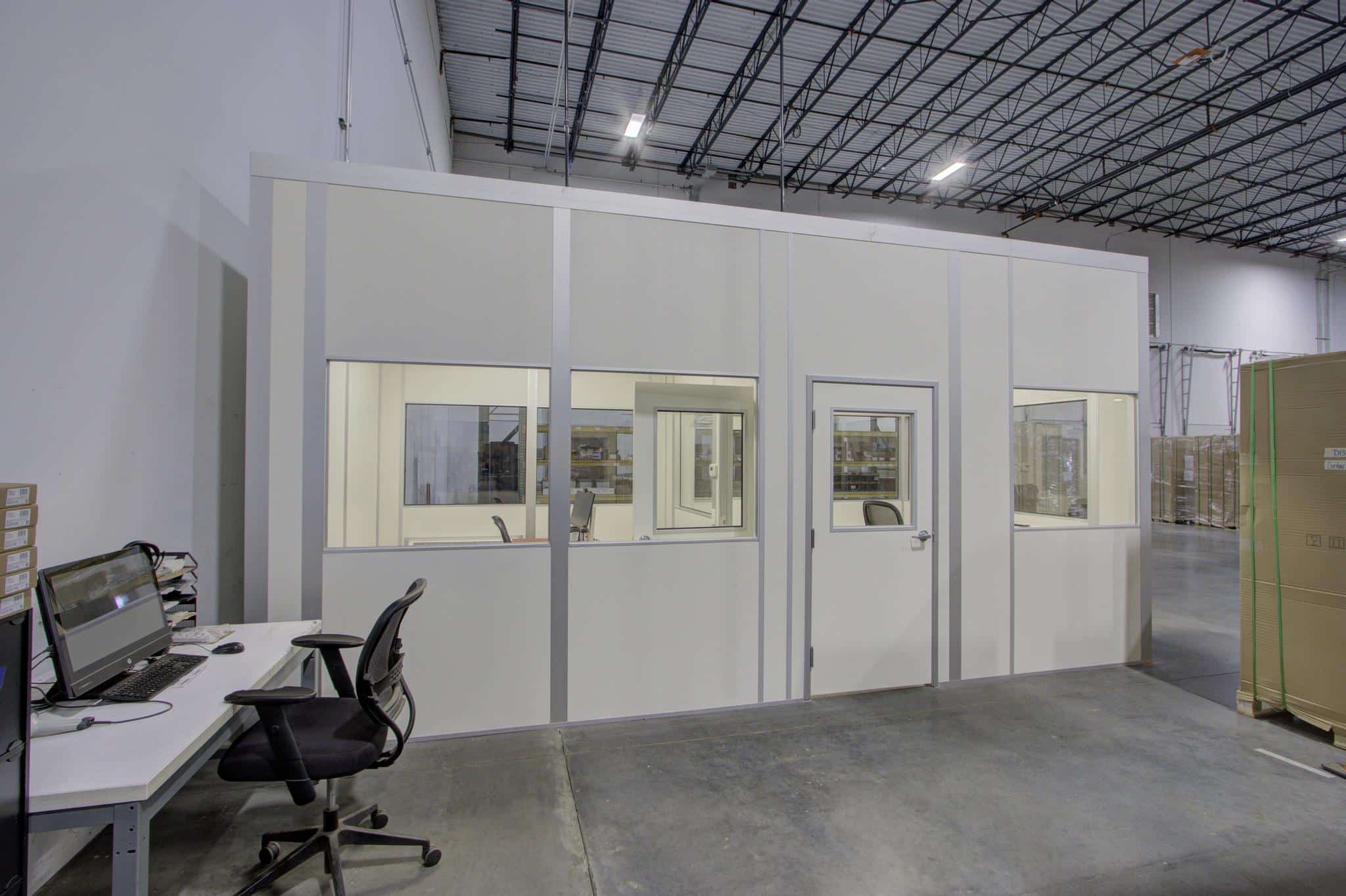 Allied Modular prefabricated inplant office with windows and a door inside a warehouse facility.