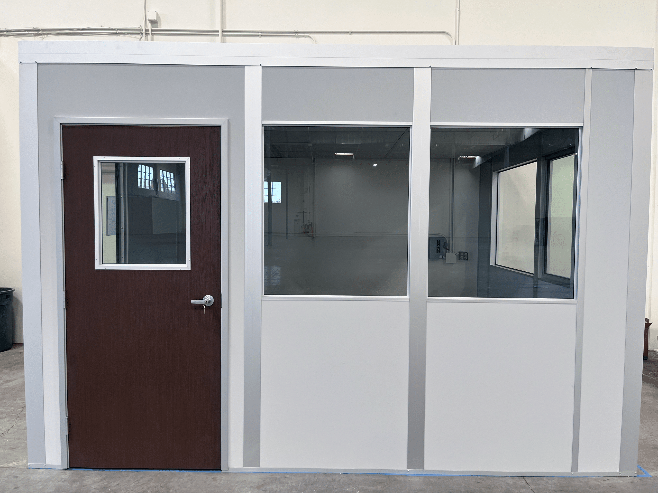 Modular office with glass panels and wood door by Allied Modular